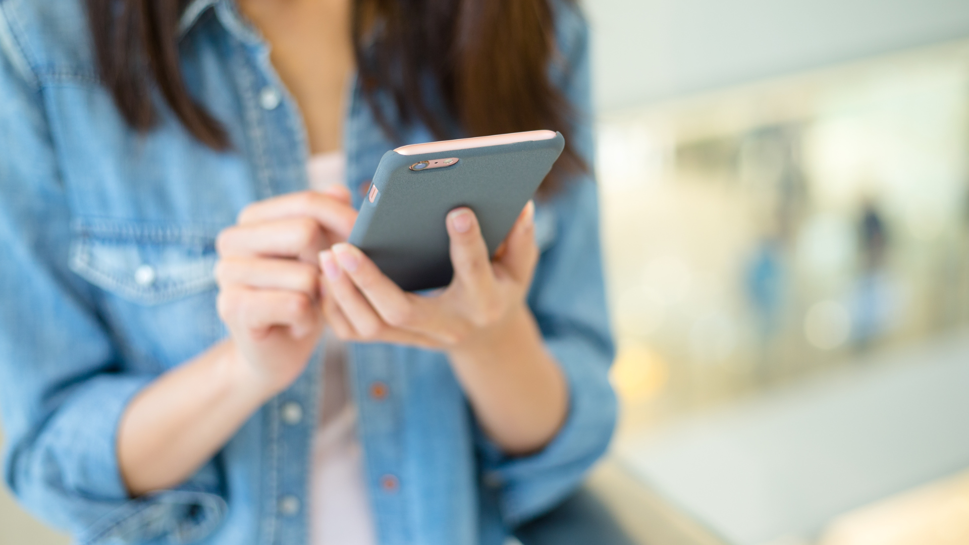 A woman using their cell phone